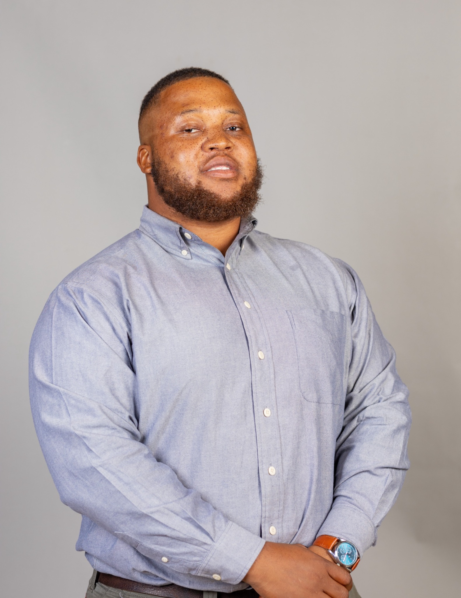 Tawanda P Mudyiwa standing in a blue shirt